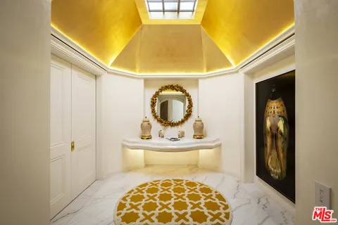 a bedroom with a large bed and a large window