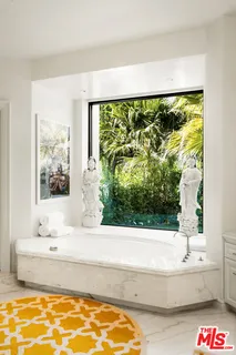 a view of a dining room with furniture wooden floor and a potted plant