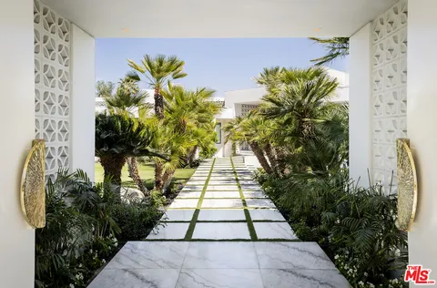 a living room with fireplace furniture and a large window