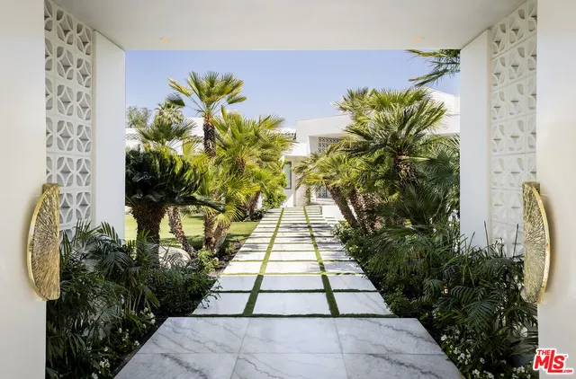 a living room with fireplace furniture and a large window