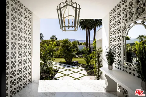 a living room with furniture fireplace and a large window