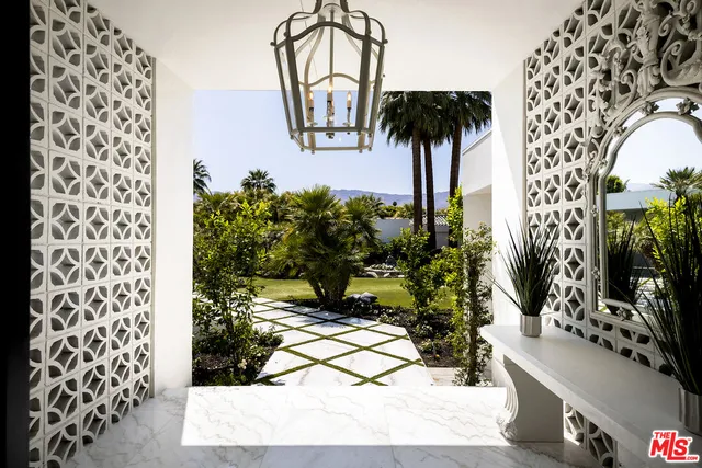 a living room with furniture fireplace and a large window