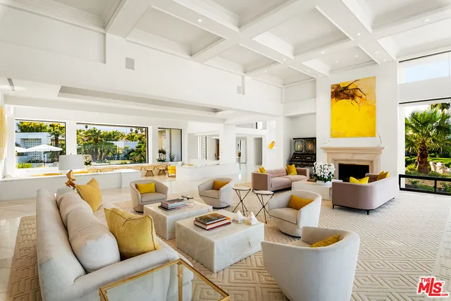 a view of a dining room and livingroom with furniture window and wooden floor