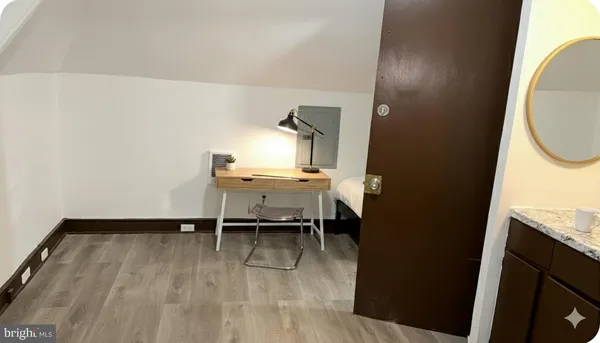 a workspace with wooden floor and a bathroom
