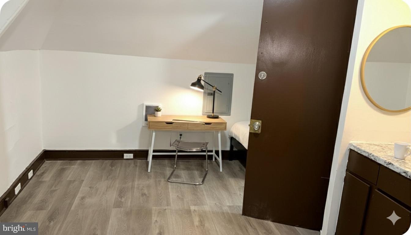 4635 Leiper Street, Unit 5 Philadelphia, PA 19124 - Photo 6 of 9 a workspace with wooden floor and a bathroom