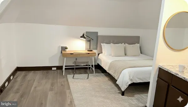 a bed room with a bed and a chair