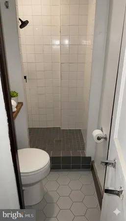 a bathroom with a toilet and a shower