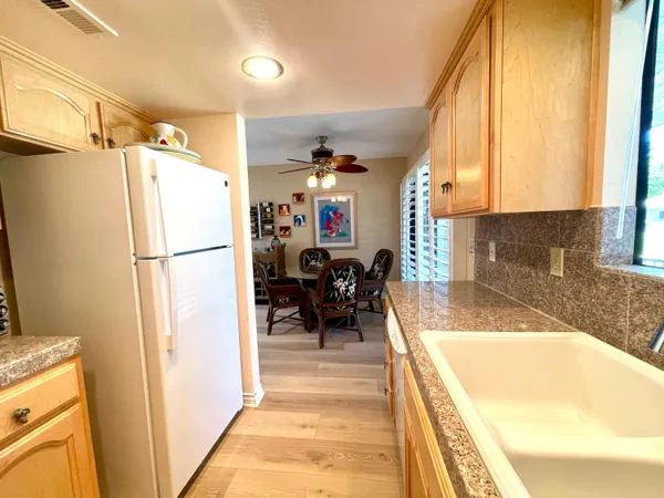 a view of a very nice looking dining room with a couch and a dining table next to a window
