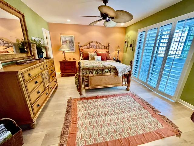 a bedroom with bed and wooden floor