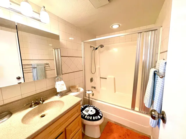 a bathroom with a double vanity sink mirror and a shower