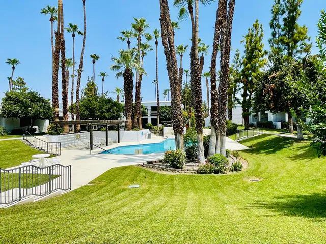 a swimming pool with outdoor seating and yard