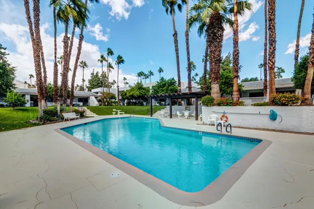 a view of a swimming pool with a table and chairs