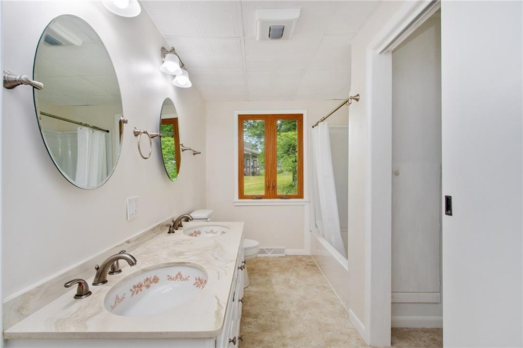 157 Wildwood Road Midland, PA 15059 - Photo 11 of 25 Hall bath with double bowl vanity sinks, decorative mirrors, large closet area!