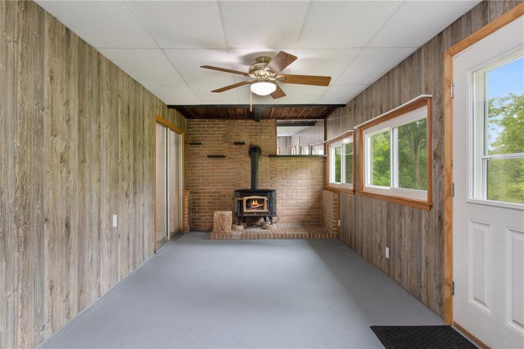 157 Wildwood Road Midland, PA 15059 - Photo 4 of 25 Large entry area/sunroom with wood burning fireplace!