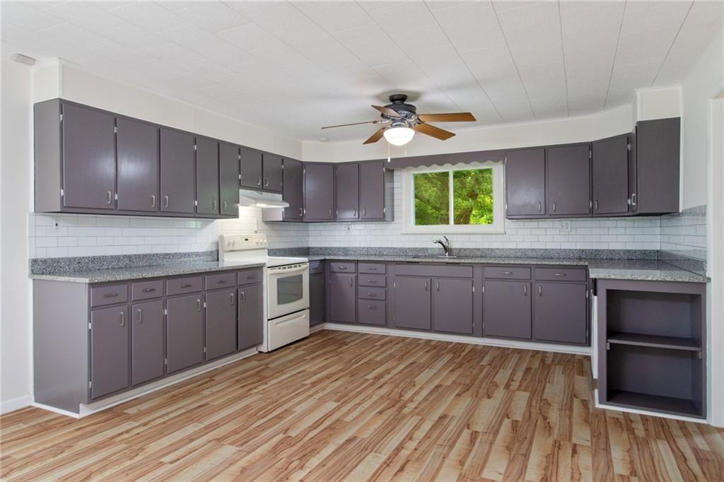157 Wildwood Road Midland, PA 15059 - Photo 5 of 25 Updated kitchen with granite counter tops, subway tile backsplash, updated cabinets, new flooring and plenty of space for an island or large table!