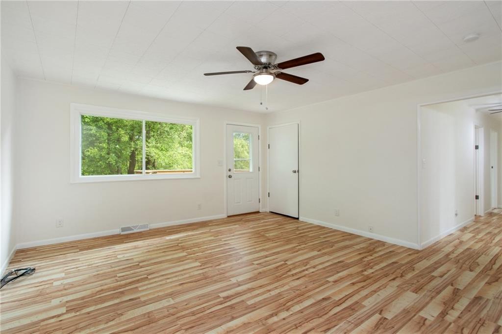 157 Wildwood Road Midland, PA 15059 - Photo 7 of 25 Family room with door leading to rear deck! All new flooring, ceiling fan, and bright!