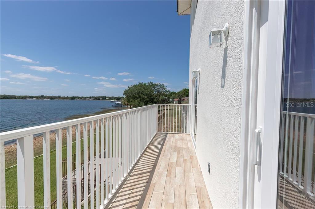 1900 Oasis Boulevard Sebring, FL 33870 - Photo 18 of 18 a view of a balcony with wooden floor and fence