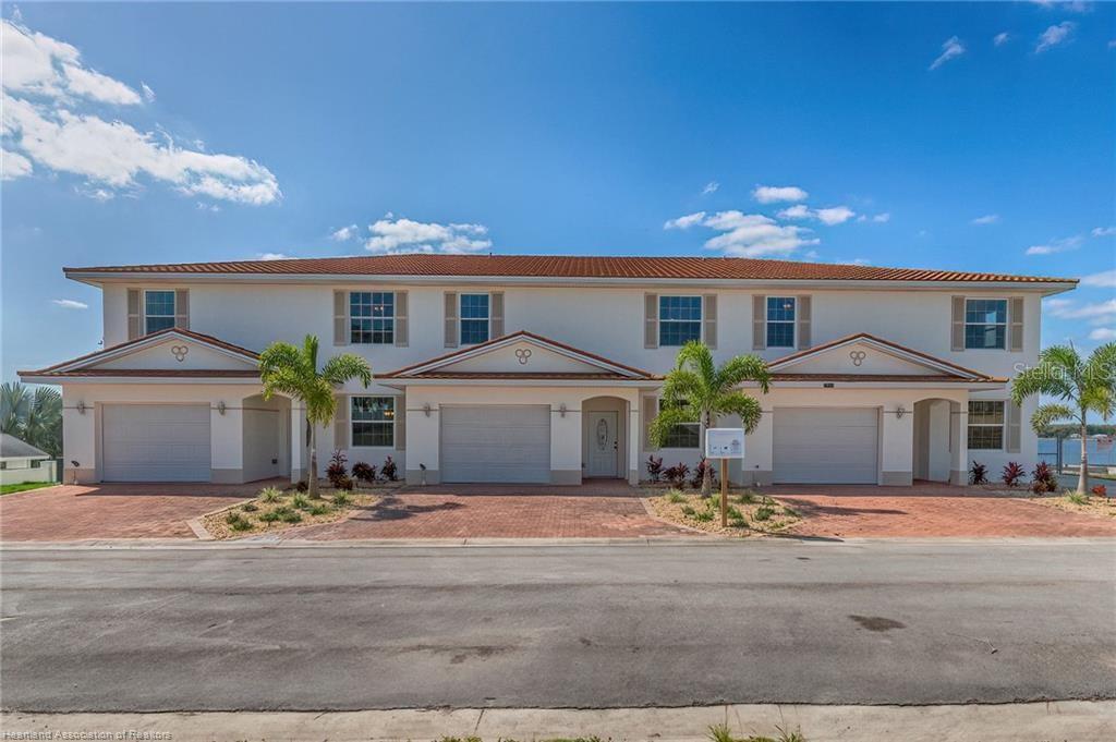 1900 Oasis Boulevard Sebring, FL 33870 - Photo 7 of 18 a front view of house with yard and trees in the background