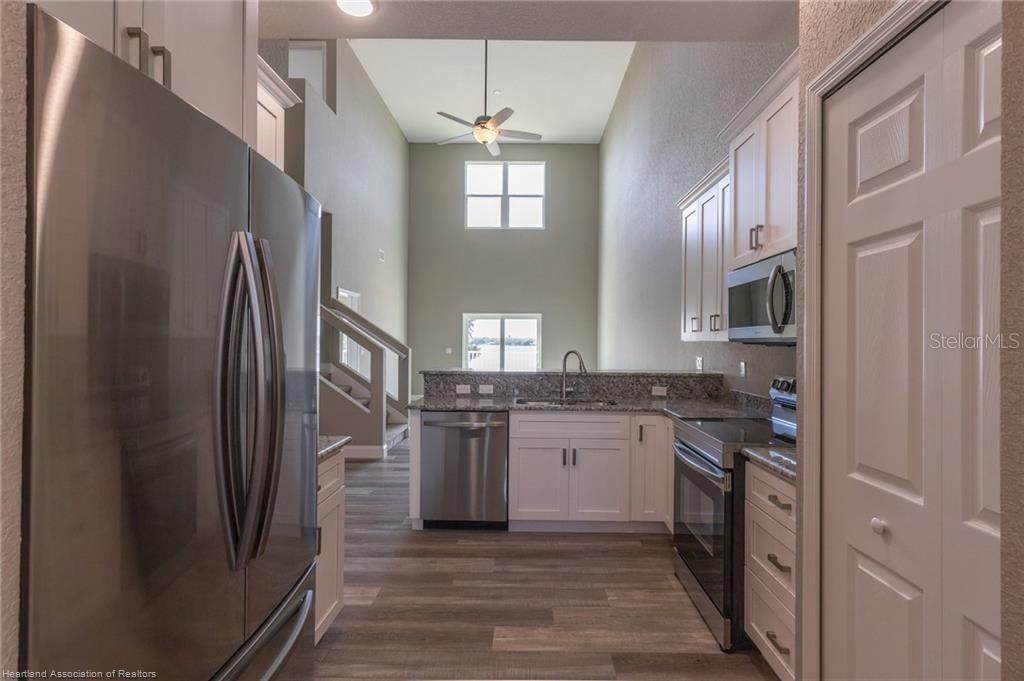 1900 Oasis Boulevard Sebring, FL 33870 - Photo 9 of 18 a kitchen with stainless steel appliances granite countertop a refrigerator and a stove