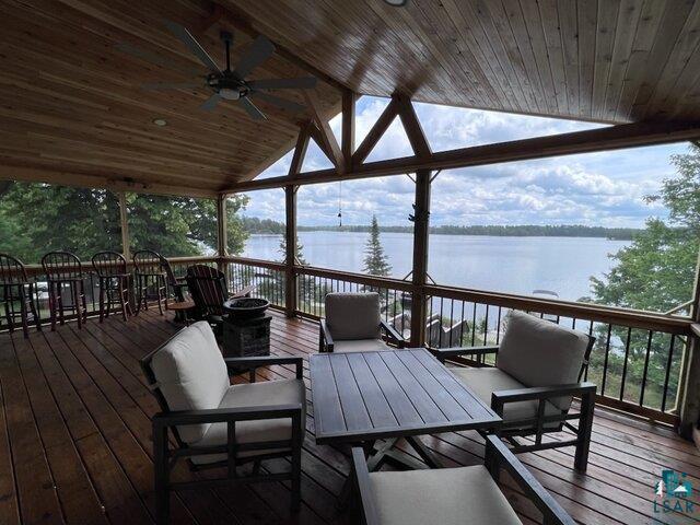 444 Fernberg Road, Unit 11 Ely, MN 55731 - Photo 11 of 19 Wooden terrace featuring a water view, outdoor dining area, ceiling fan, and an outdoor hangout area