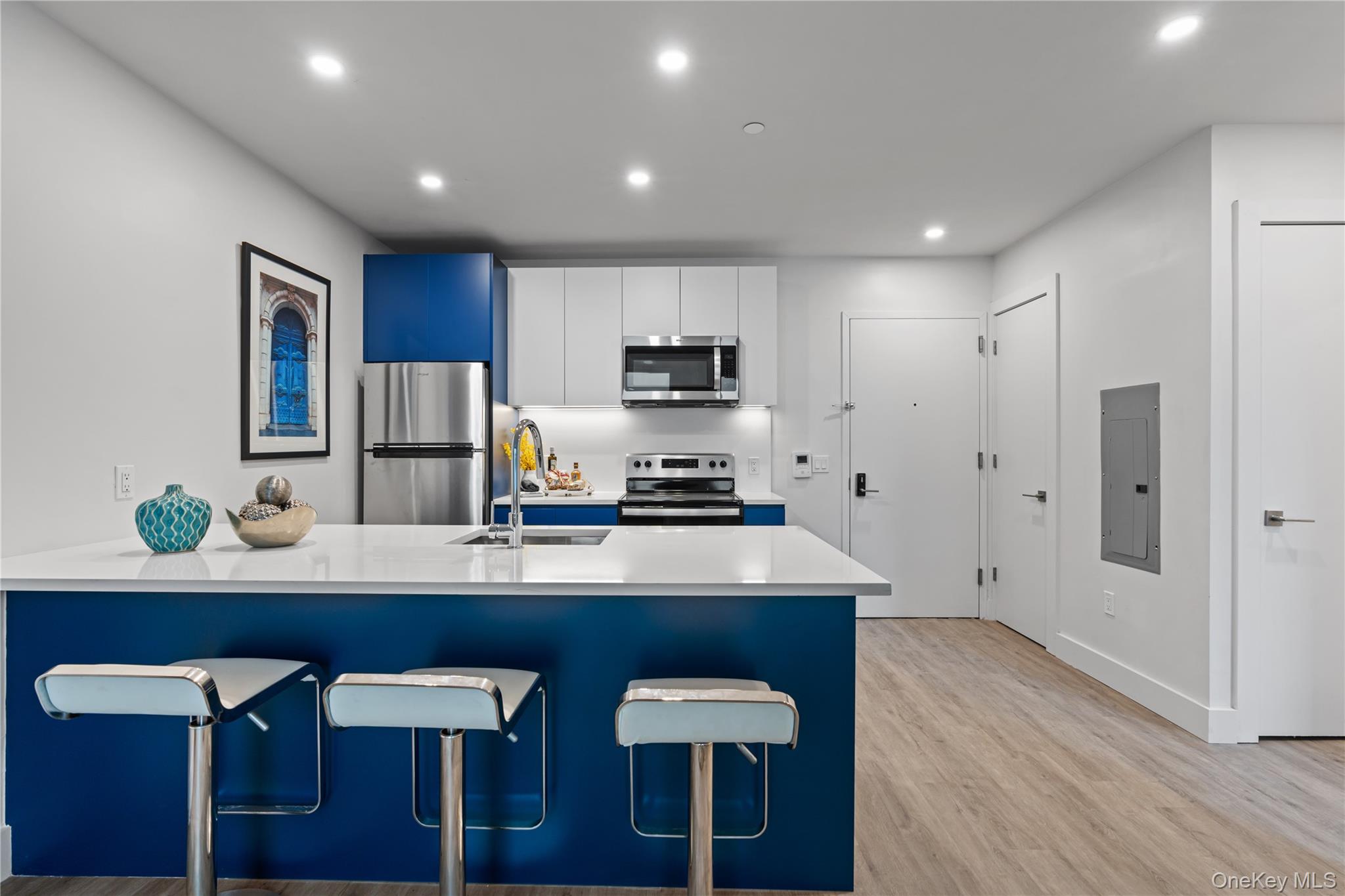 a kitchen with a sink cabinets and refrigerator