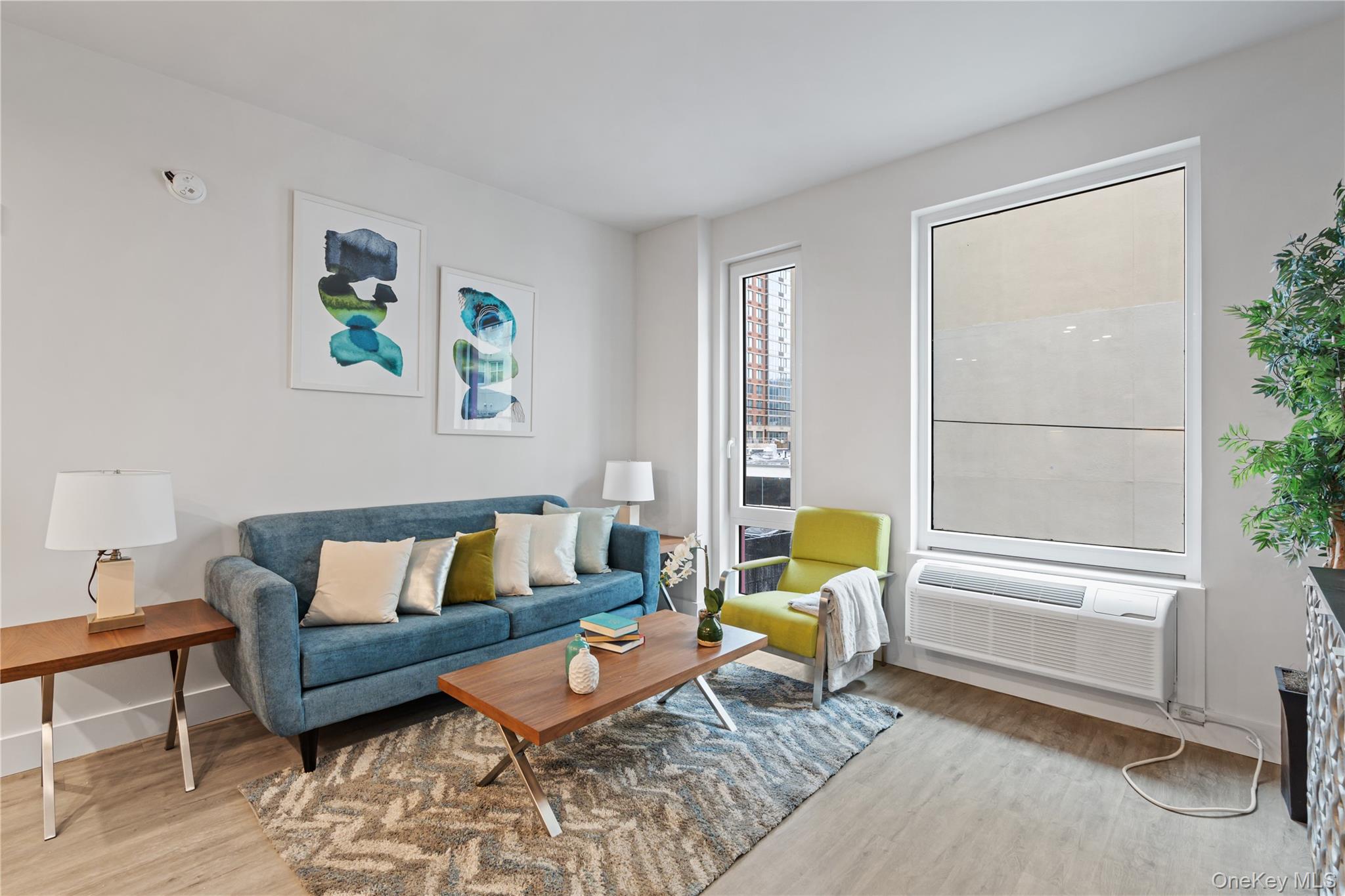 40 Westchester Place, Unit 602 New Rochelle, NY 10801 - Photo 3 of 6 a living room with furniture and a window