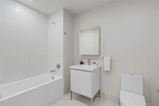 a bathroom with a sink a toilet and bathtub