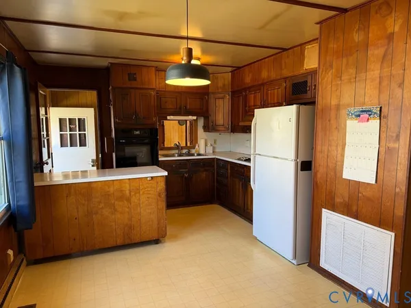a kitchen with refrigerator cabinets and a refrigerator