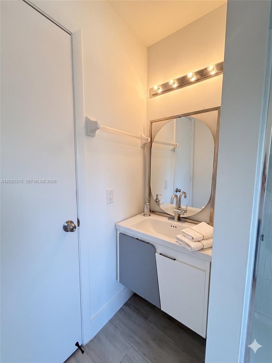 13 Southwest 3rd Street, Unit 13 Pompano Beach, FL 33060 - Photo 22 of 44 a bathroom with a granite countertop sink a mirror and shower