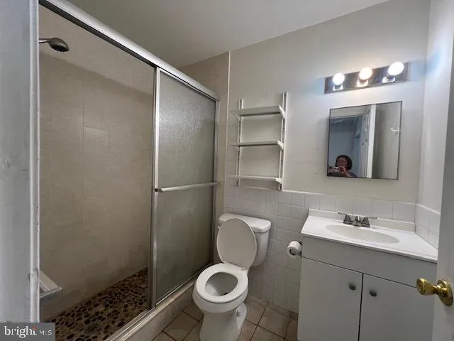 a bathroom with a toilet a sink and shower
