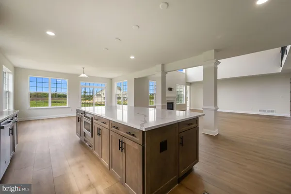 a kitchen with stainless steel appliances granite countertop a lot of counter space and wooden floors