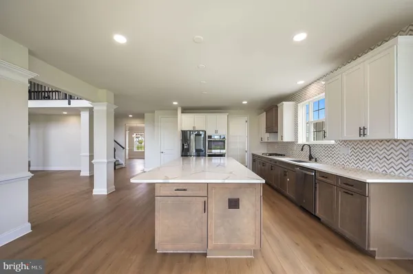 a kitchen with stainless steel appliances granite countertop a sink stove and wooden floor