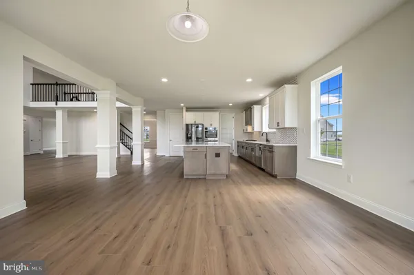a view of kitchen with wooden floor and electronic appliances
