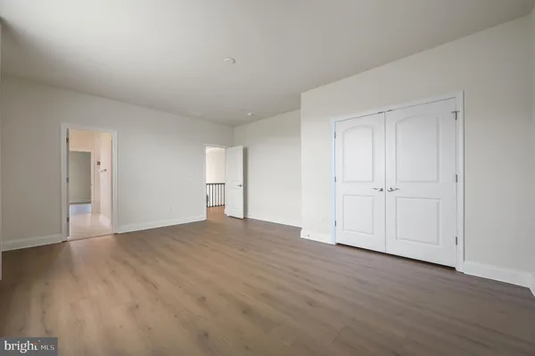 a view of an empty room and wooden floor