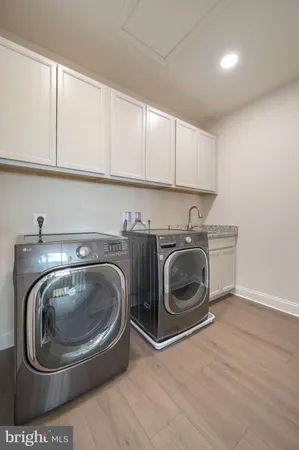 a utility room with sink dryer and washer