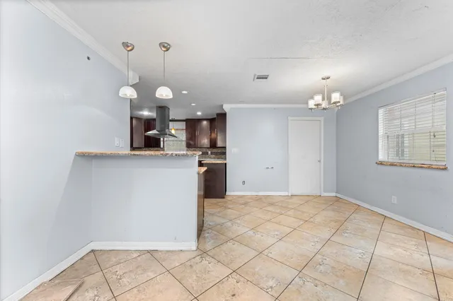 a view of a kitchen with a sink and chandelier fan