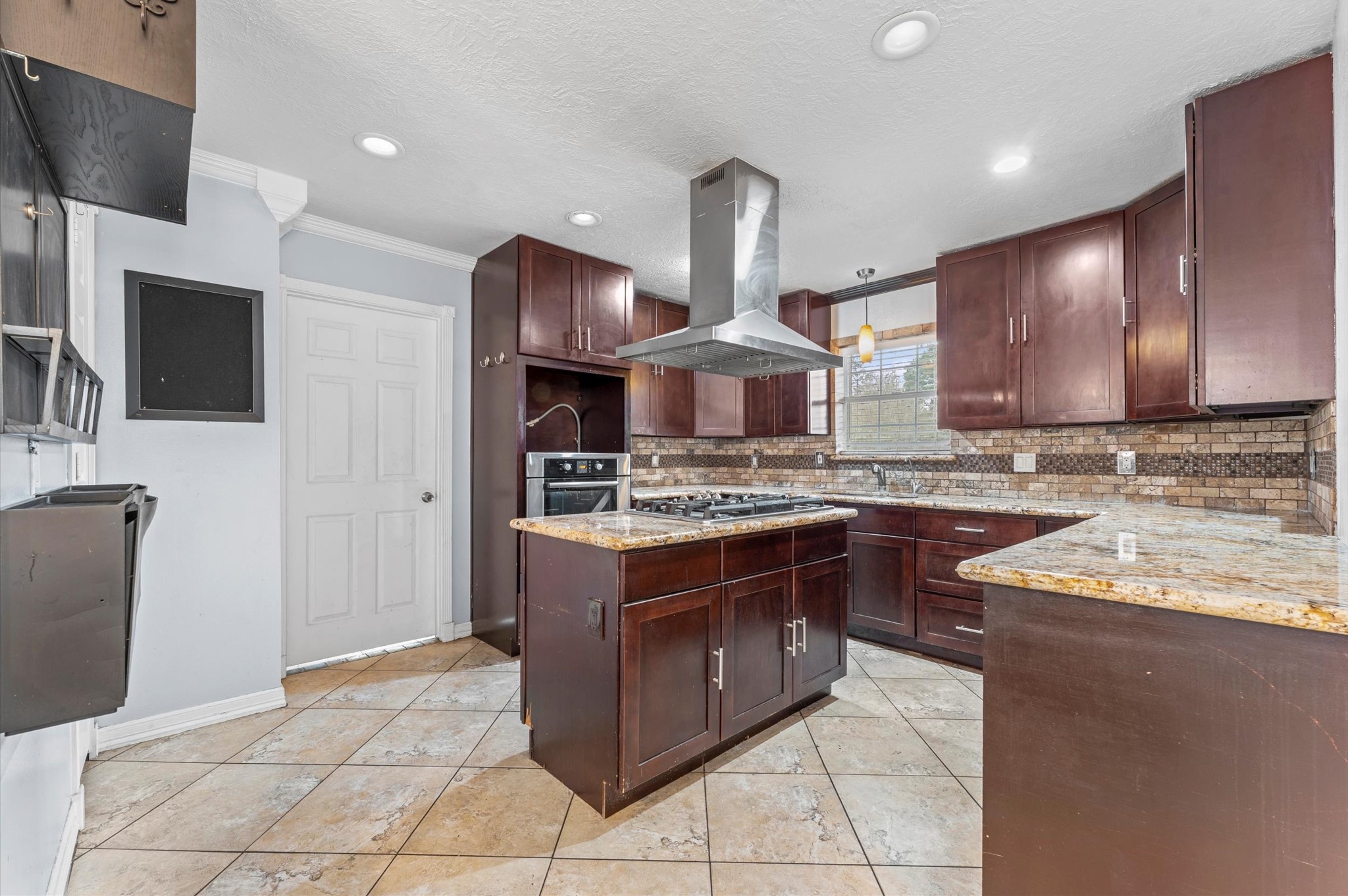 8710 Congo Lane Houston, TX 77040 - Photo 14 of 50 a kitchen with stainless steel appliances granite countertop a stove a sink and a refrigerator