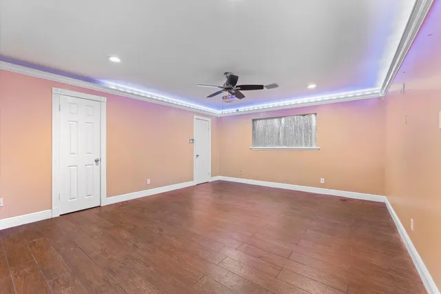 a view of an empty room with a ceiling fan