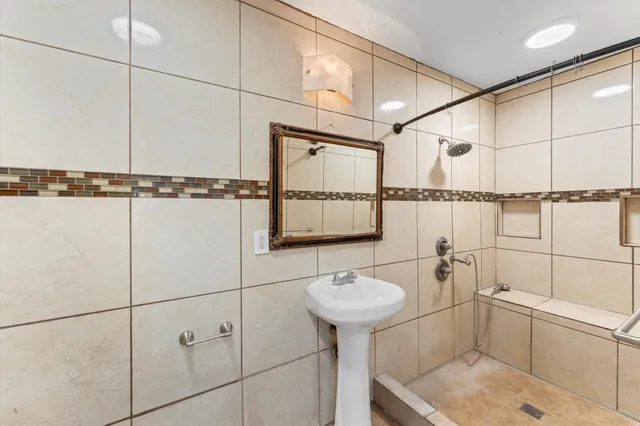 a bathroom with a sink toilet and shower