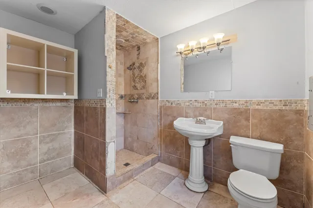 a bathroom with a toilet sink and shower