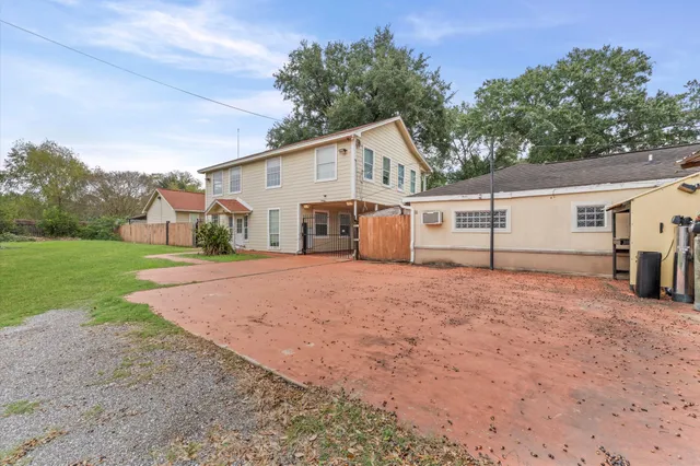 a view of a white house with a yard and garage