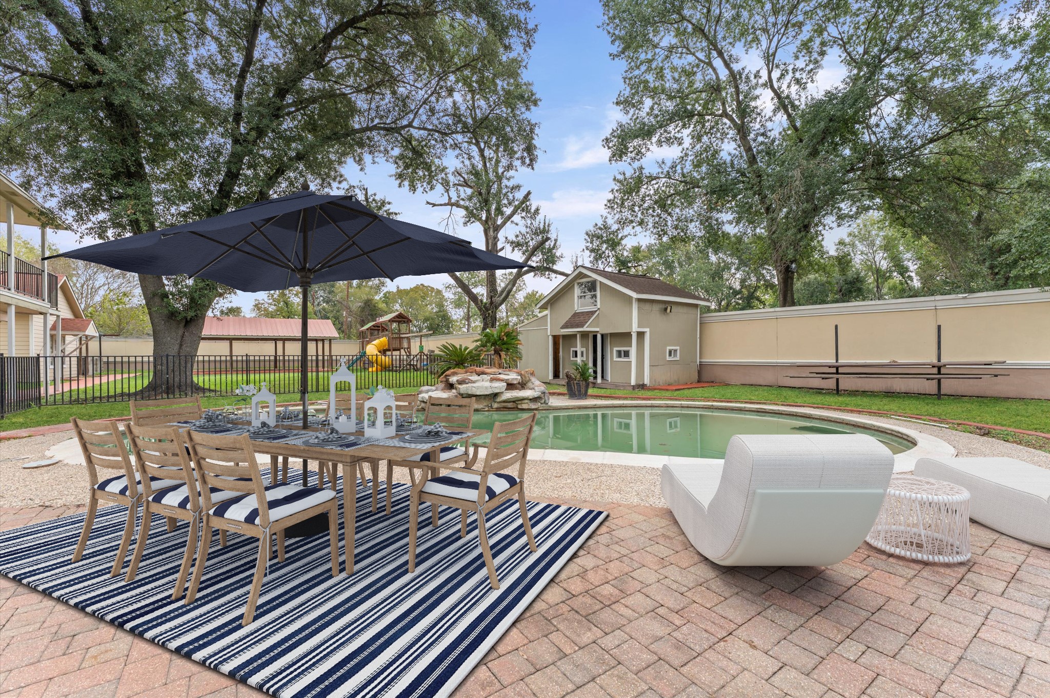 8710 Congo Lane Houston, TX 77040 - Photo 49 of 50 a view of a patio with couches table and chairs under an umbrella with a barbeque