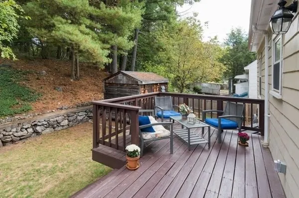 a view of a deck with chairs and wooden floor
