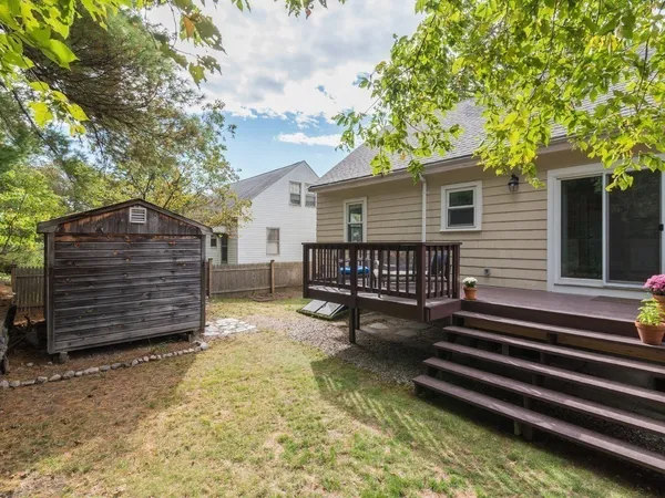 a view of a house with a yard and wooden fence