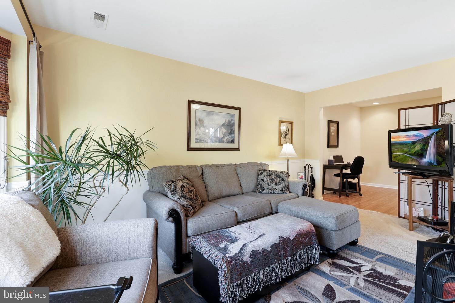 6029 Sunset Ridge Court Centreville, VA 20121 - Photo 3 of 31 a living room with furniture a flat screen tv and a large window