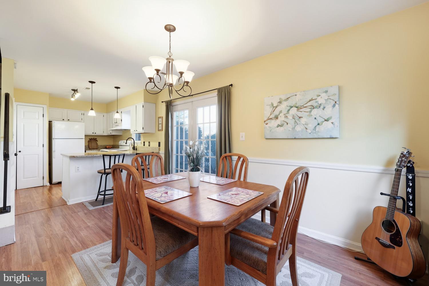6029 Sunset Ridge Court Centreville, VA 20121 - Photo 9 of 31 a view of a dining room with furniture a chandelier and wooden floor
