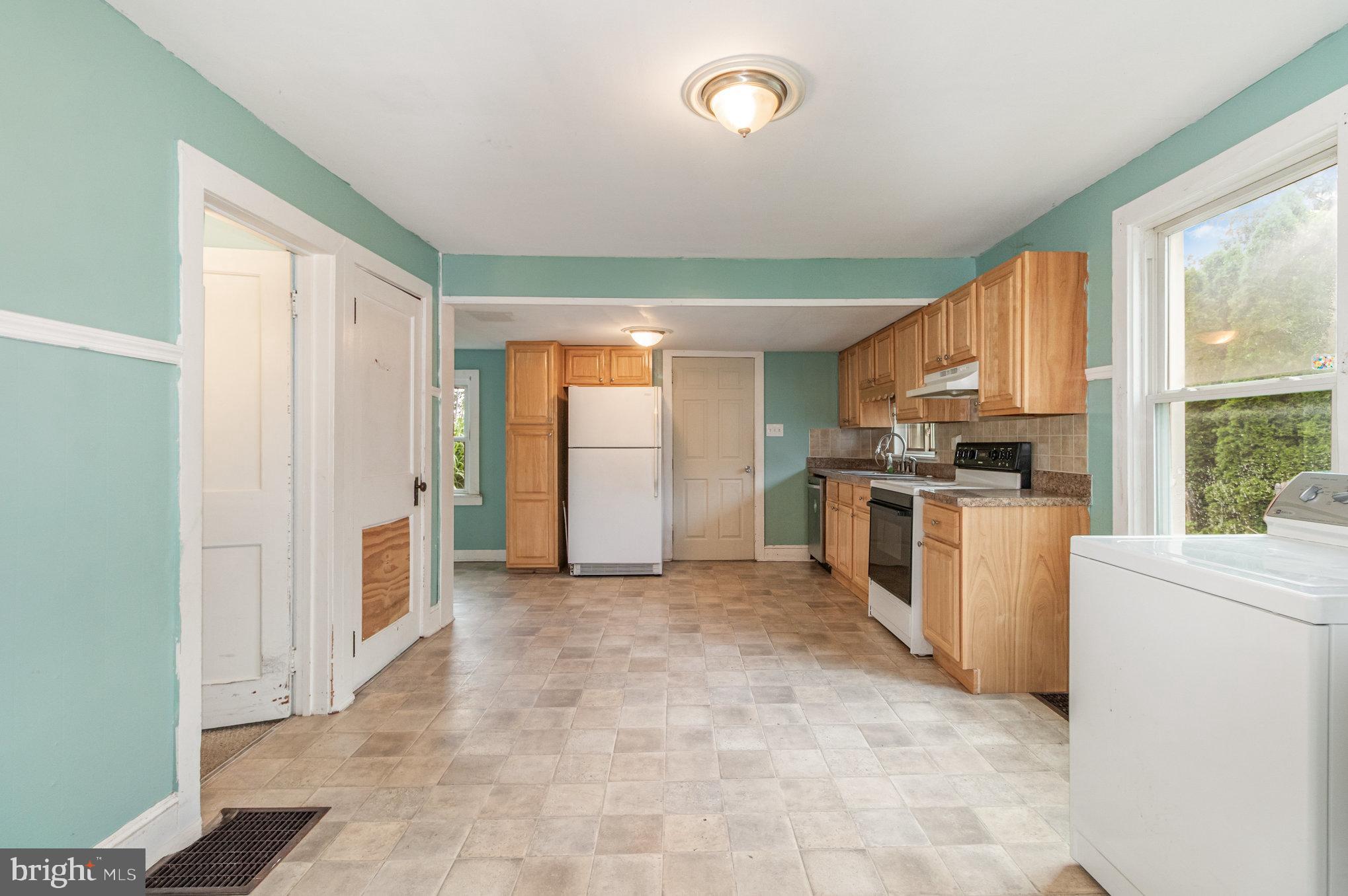 273 Copenhaffer Road York, PA 17404 - Photo 7 of 24 a view of a kitchen with a sink and dishwasher a refrigerator with wooden floor