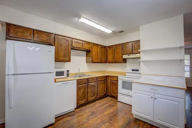 a kitchen with stainless steel appliances granite countertop refrigerator sink and cabinets
