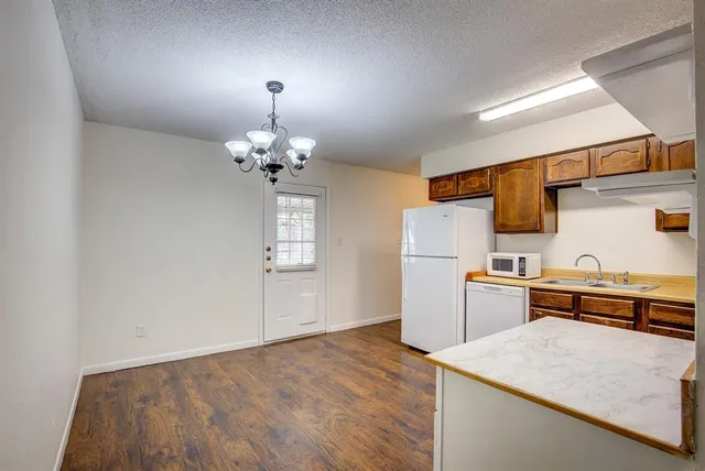 a kitchen that has a lot of cabinets in it