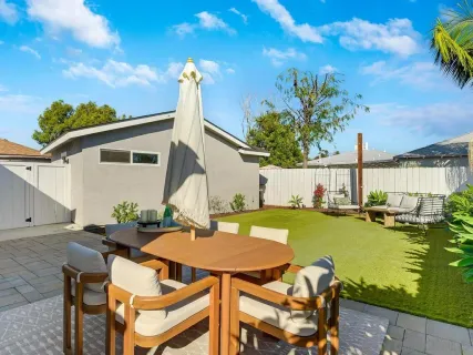 a view of a patio with table and chairs and potted plants